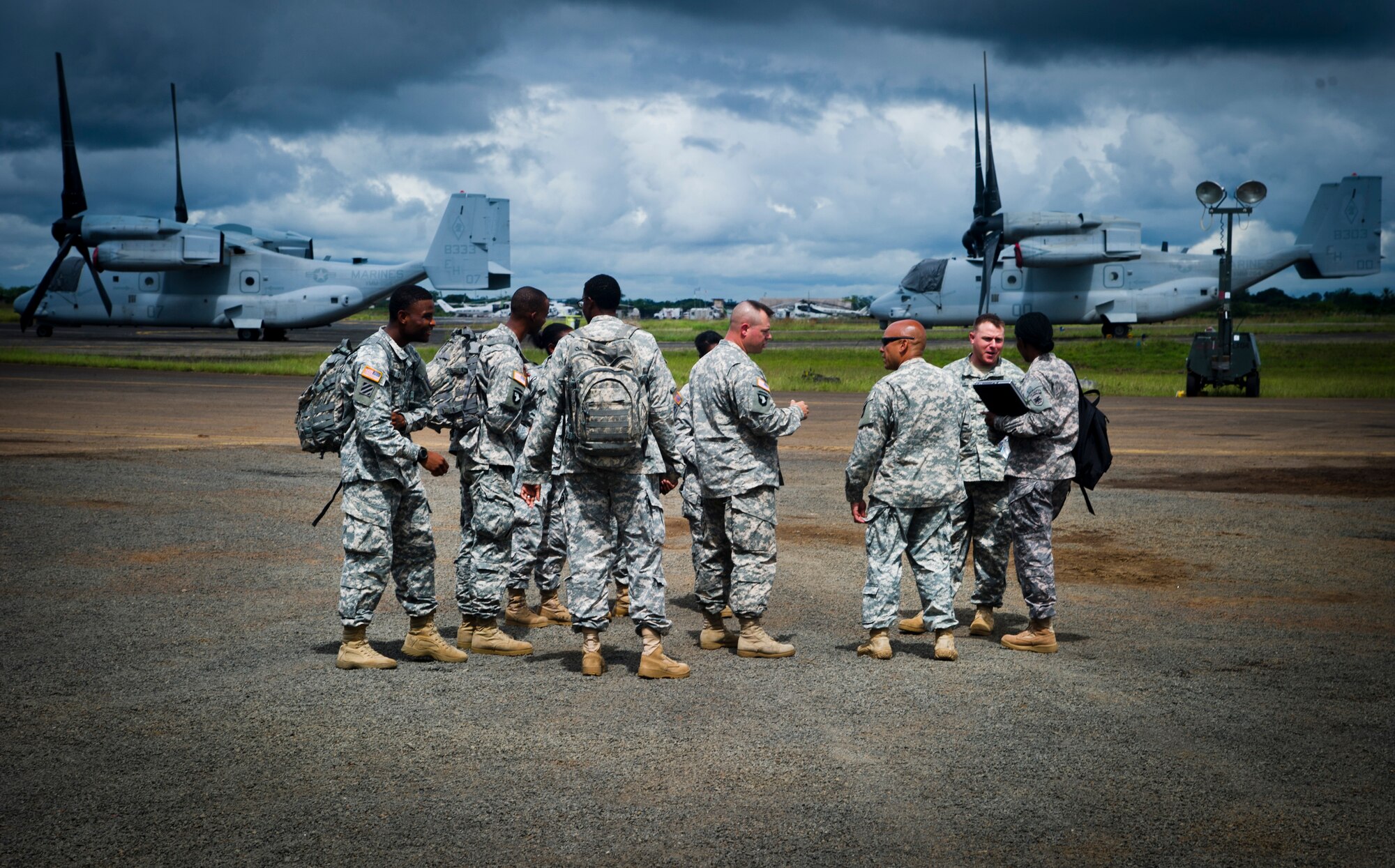 ROBERTS INTERNATIONAL AIRPORT, Republic of Liberia - U.S. Army Soldiers of the 688th Rapid Port Opening Element assigned to Joint Base Langley-Eustis, Va., and part of the Joint Task Force-Port Opening team, discuss the day's events during Operation UNITED ASSISTANCE here, October 15, 2014. The 688 RPOE is working in support of the USAID-led interagency team and the international community to provide effective and efficient delivery of assistance to the Government of Liberia to end the EVD outbreak. (U.S. Air Force photo/Staff Sgt. Gustavo Gonzalez/RELEASED)