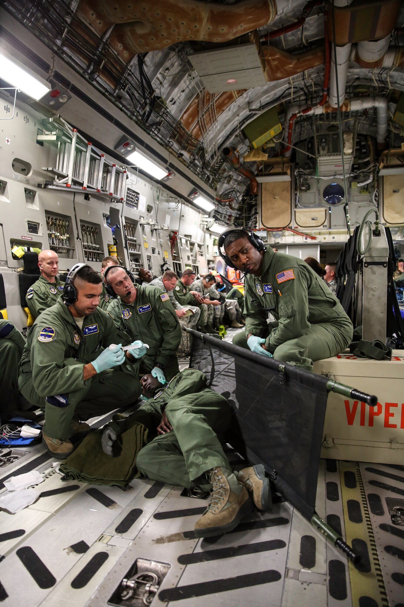 Airmen from the 315th Aeromedical Evacuation Squadron at Joint Base Charleston, S.C.  conduct medical training in the cargo compartment of a C-17 Globemaster III Oct. 16, 2014 while on a training mission en route to Key West Naval Air Station, Fla. The four-day training mission included 117 members from the 315th AW and was part of the wing’s Unit Effectiveness Inspection training, which is the U.S. Air Force’s new way of evaluating a unit’s wartime, contingency and force sustainment readiness. (U.S. Air Force Photo by Tech. Sgt. Shane Ellis)