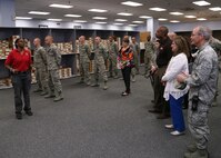 Lynne Carter, 502nd Logistics Readiness Squadron clothing issue assistant flight chief, gives a tour of clothing issue to 502nd Air Base Wing honorary commanders Oct. 10, 2014 at Joint Base San Antonio-Lackland. Honorary commanders toured locations at JBSA-Lackland and JBSA-Camp Bullis to get a better understanding of the missions that take place at the two locations, and to build a stronger bond between the local community and the military. (U.S. Air Force photo by Airman 1st Class Stormy Archer/Released)