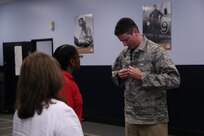 Alan Kramer, 502nd Air Base Wing honorary commander, gets fitted for an Airman Battle Uniform by Lynne Carter, 502nd Logistics Readiness Squadron clothing issue assistant flight chief Oct. 10, 2014 at Joint Base San Antonio-Lackland clothing issue. Honorary commanders toured locations at JBSA-Lackland and JBSA-Camp Bullis to get a better understanding of the missions that take place at the two locations, and to build a stronger bond between the local community and the military. (U.S. Air Force photo by Airman 1st Class Stormy Archer/Released)