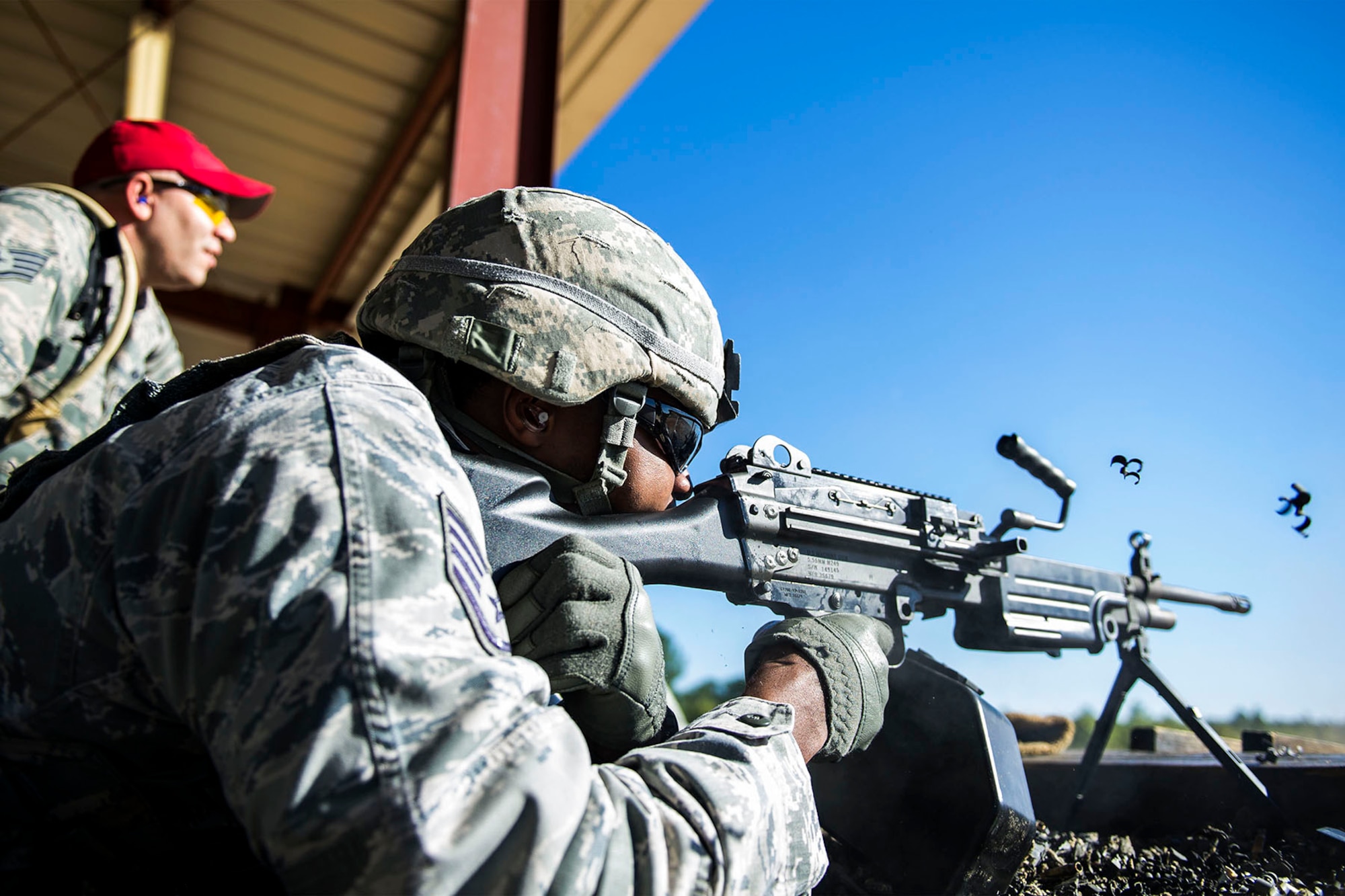 A U.S. Airman assigned to the 169th Security Forces Squadron at McEntire Joint National Guard Base, S.C., fires the M249 light machine gun in the prone position during heavy weapons training at Fort Jackson, S.C., Oct. 5, 2014. Routine weapons training ensures Airmen of the South Carolina Air National Guard are trained and prepared to perform their mission at home and abroad.   (U.S. Air National Guard photo by Tech. Sgt. Jorge Intriago/Released)