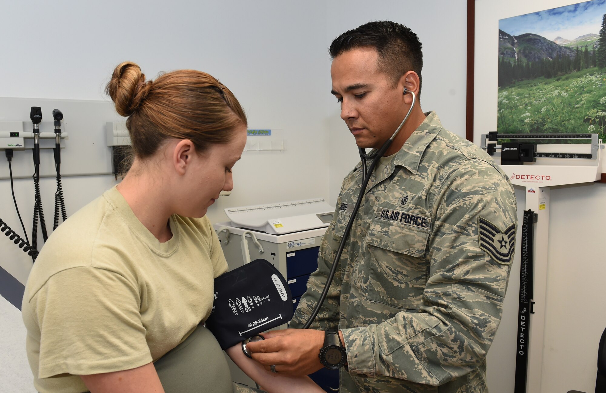 Senior Airman Kassi Borgard, 460th Medical Group Aerospace Medical Service journeyman, has her blood pressure taken by Tech Sgt. Danny Wong, 460th Medical Support Squadron aerospace medical technician, during a medical screening at the clinic on base. Wong has worked as a medic in military emergency rooms across the country and has deployed to Germany and Afghanistan, working as a direct influence in the safe treatment and return of warfighters. (U.S. Air Force photo by Airman 1st Class Samantha Saulsbury/Released)