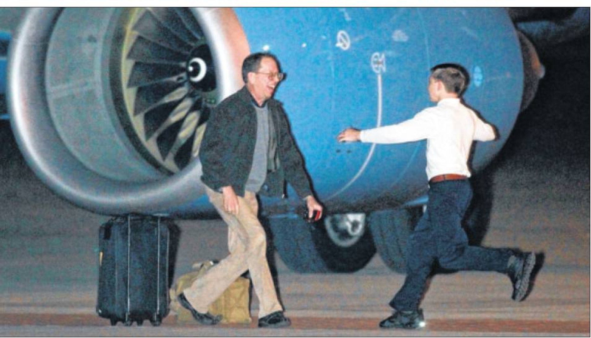 Jeffrey Fowle prepares to embrace one of his children after arriving at Wright-Patterson Air Force Base Oct. 22. Fowle returned to the United States after five months of detention in North Korea. (Cox Media Group Ohio photo by Jim Witmer)