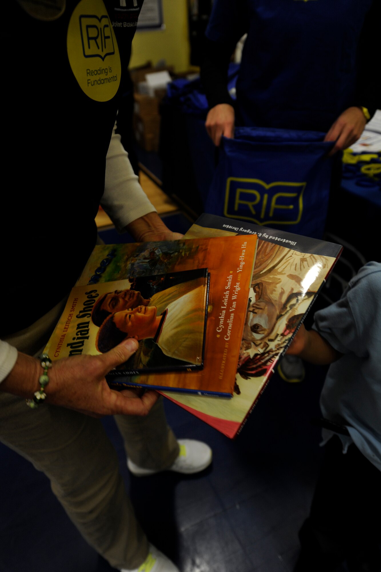 Children at Joint Base Andrews Youth Center receive free books from the Reading is Fundamental program on Joint Base Andrews, Md., Oct 24, 2014. Copies included were Cynthia Leitich Smith’s award winning children’s books: “Indian Shoes” and “Jingle Dancer”, along with R. Gregory Christie’s illustrated book, “Philip Reid Saves the Statue of Freedom”. (U.S Air Force photo/ Senior Airman Nesha Humes)