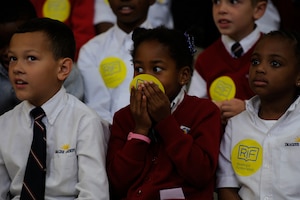 Youth Center children react after hearing about the famous author and illustrator they are about to meet at Joint Base Andrews, Md., Oct 24, 2014. Cynthia Leitich Smith, New York Times Best-Selling author and R. Gregory Christie, award- winning children book illustrator, talk with the children about their work while the Reading is Fundamental program delivers free copies of their books to JBA youth. RIF is the largest children’s literacy nonprofit organization in the United States. (U.S Air Force photo/ Senior Airman Nesha Humes)