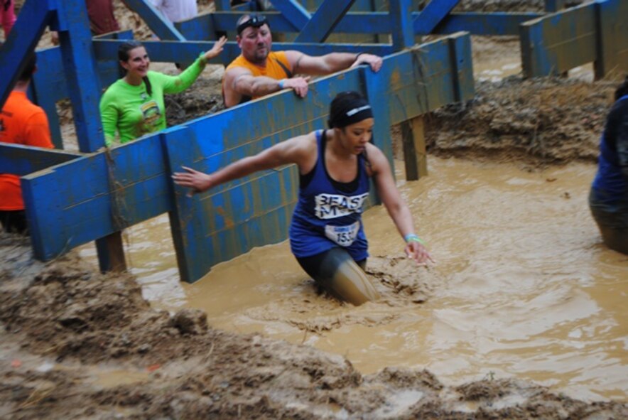 Capt. Michelle Rogers, 512th Maintenance Group executive officer, works her way through the obstacles at the Mid-Atlantic Savage Race Oct.11, 2014, at Hopkins Farm, Md. The Air Force Reserve was the premiere sponsor for the obstacle race, which is a 4-to-6-mile race that has more than 20 obstacles along the way. (Courtesy Photo)