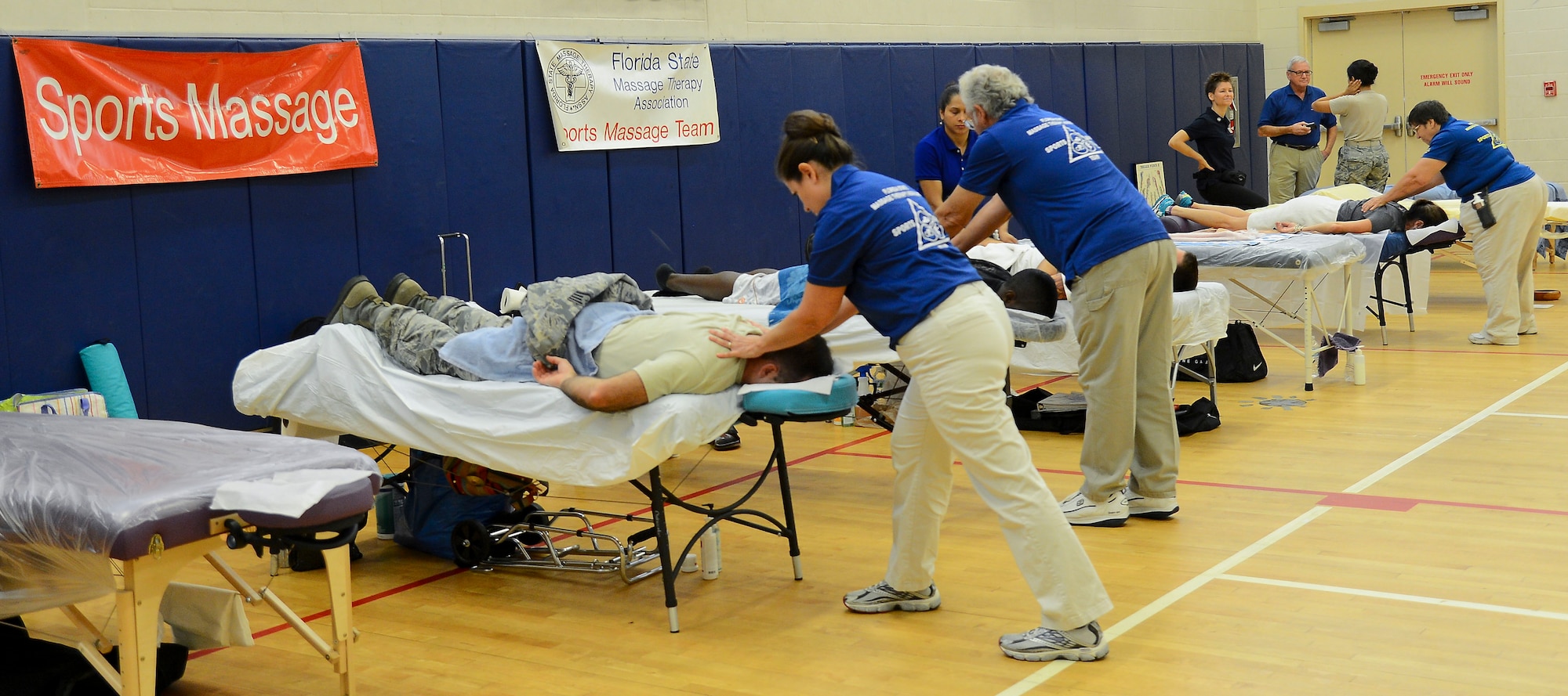 Representatives with the Florida State Massage Therapy Association give Team MacDill the opportunity to experience various forms of massage therapy in the Short Fitness & Sports Center at MacDill Air Force Base, Fla., Oct. 21, 2014.The sports massage section of the event helped patrons understand the importance of preparing the body for a sport through stretching. (U.S. Air Force photo by Airman 1st Class Danielle Conde/Released)  