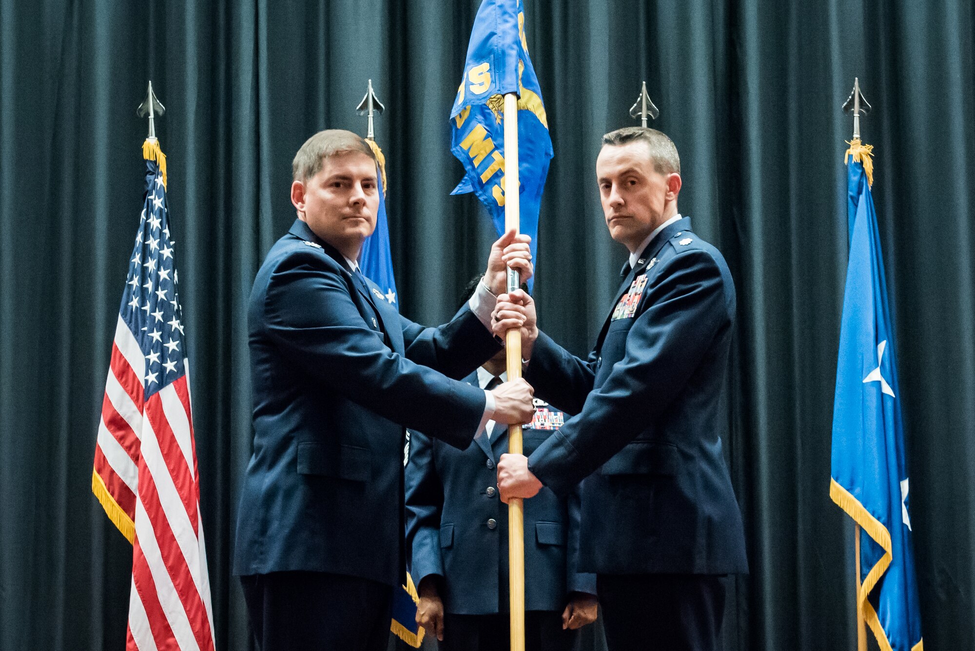 On left, Col. Jay L. Junkins, U.S. Air Force Expeditionary Operations School commander, passes the guidon to Lt. Col. William Wallis, 423rd Mobility Training Squadron commander, at the USAF Expeditionary Center Reorganization Ceremony Oct. 22, 2014, on Joint Base McGuire-Dix-Lakehurst, N.J. The ceremony combined the newly re-designated 423rd Mobility Training Squadron with the function of the previous Mobility Operations School and the 422nd Joint Tactics Squadron. The USAF Expeditionary Operations School educates and trains general purpose and Mobility Air Forces personnel across the full range of required expeditionary knowledge and skills.(U.S. Air Force photo by Russ Meseroll/Released)
