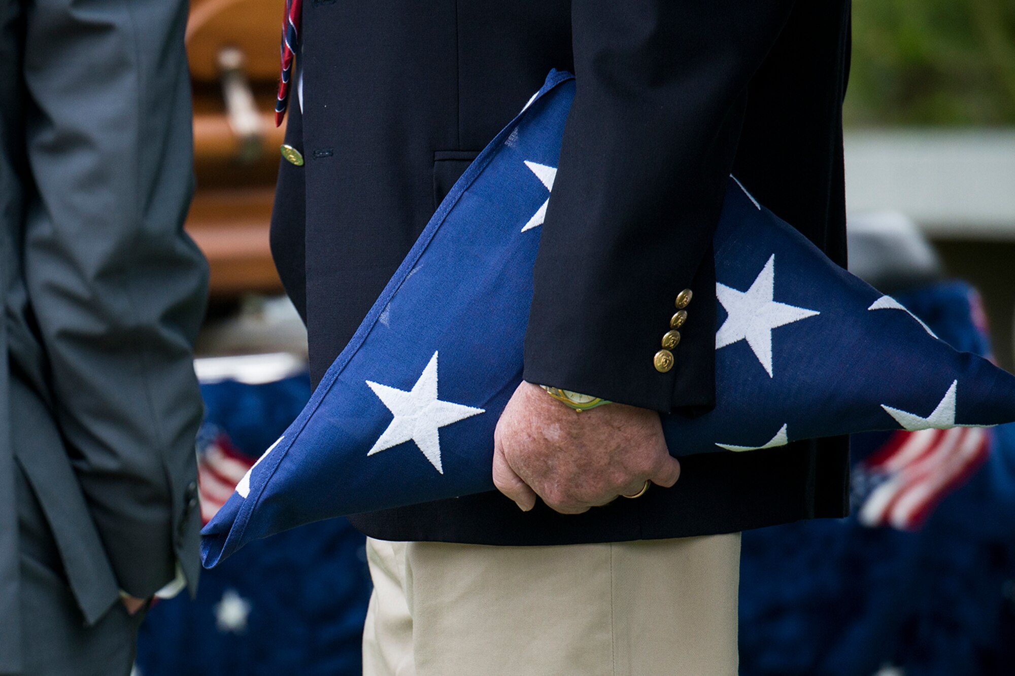 Will McCrocklin holds an American Flag presented to him during the funeral service for his dad, Claude McCrocklin, Oct. 23, 2014, Shreveport, La. McCrocklin, a World War II B-24 bombardier and Prisoner of War, died Oct. 18, 2014, after a lengthy illness. He was 93. (U.S. Air Force photo by Master Sgt. Greg Steele/Released)