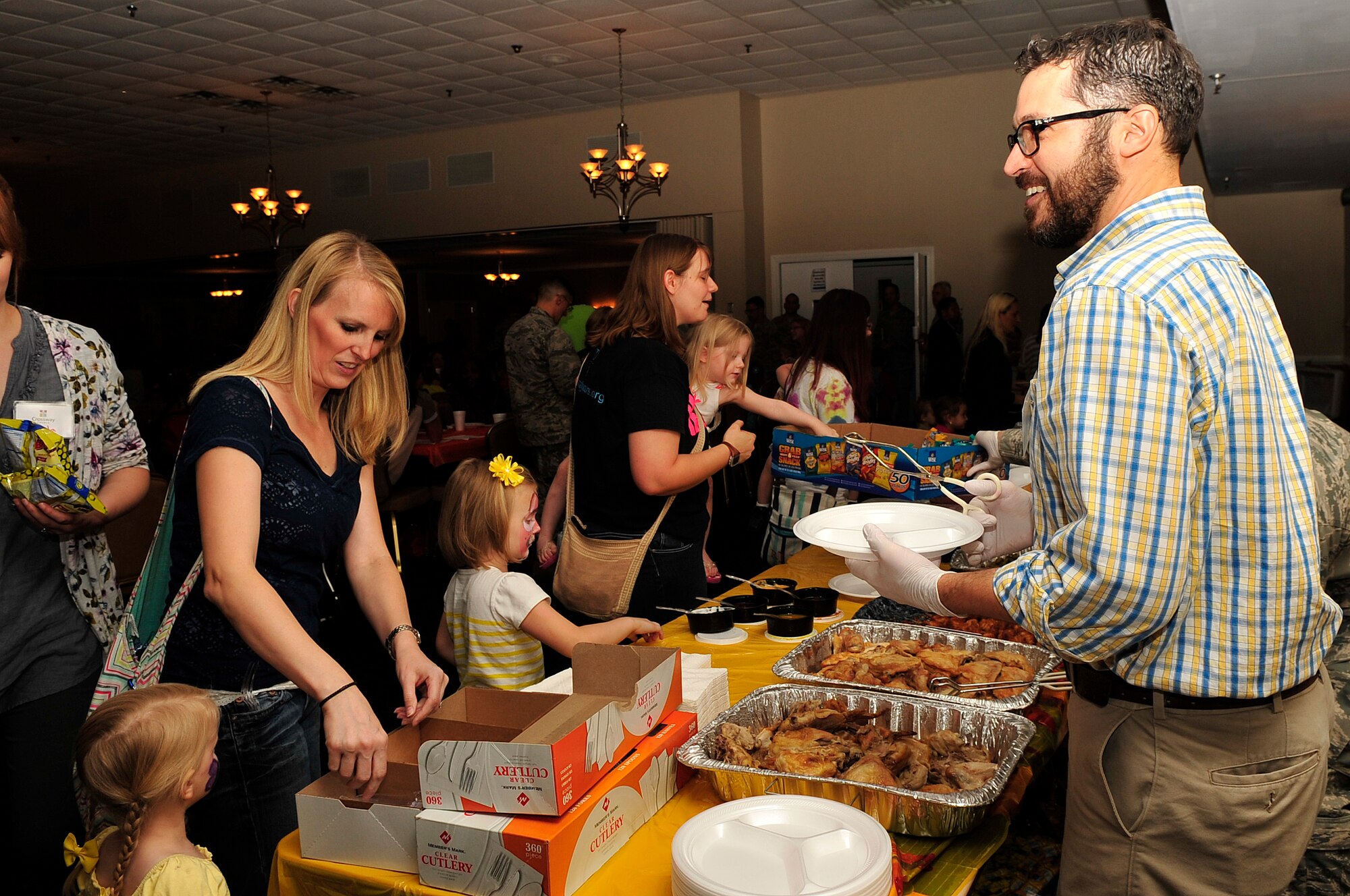 Members of Team Seymour get their fill of food and snacks during a “Hearts Apart” event Oct. 24, 2014, at Seymour Johnson Air Force Base, North Carolina. The event focused on relieving the pressures families sustain when a member is deployed and served as a venue to ensure families are connected with the wing’s many helping agencies and resources. (U.S. Air Force photo/Airman 1st Class Shawna Keyes)
