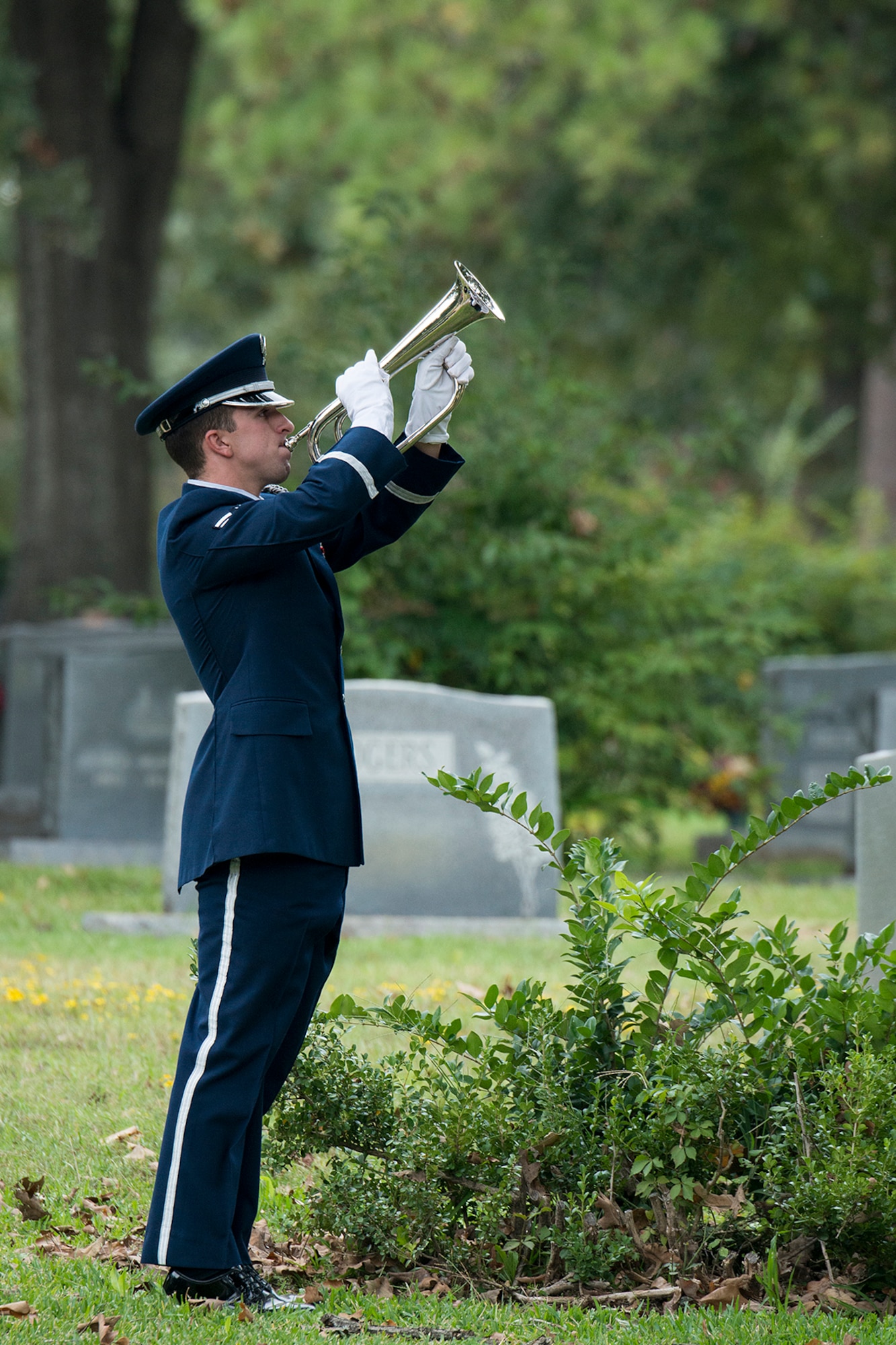 A member of the Barksdale Honor Guard plays Taps during the funeral service for Claude McCrocklin, Oct. 23, 2014, Shreveport, La. McCrocklin, a World War II B-24 bombardier and Prisoner of War, died Oct. 18, 2014, after a lengthy illness. He was 93. (U.S. Air Force photo by Master Sgt. Greg Steele/Released)