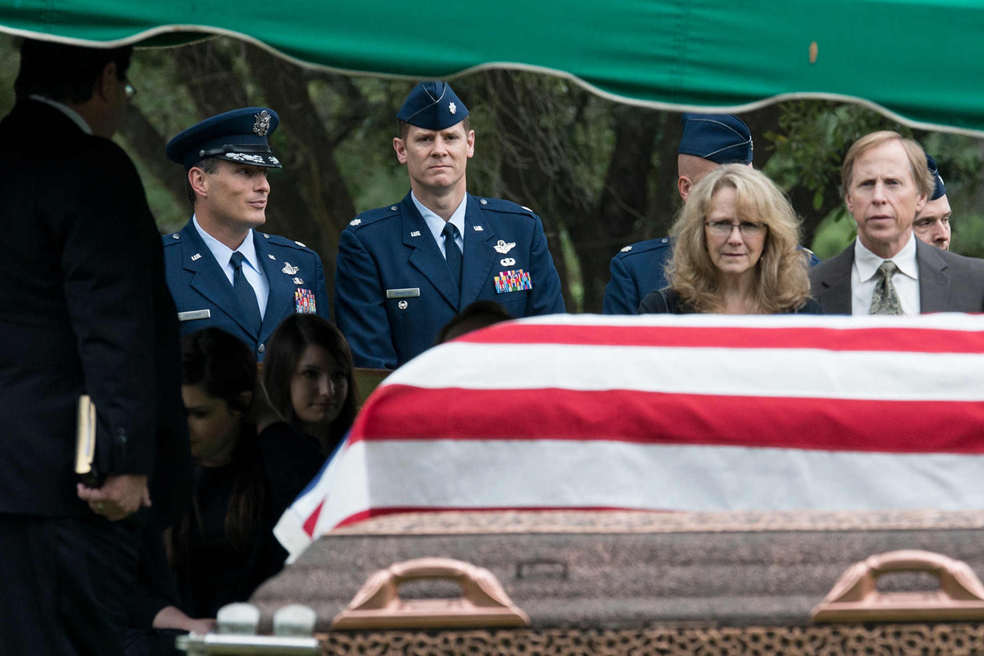U.S. Air Force Lt. Col. Heath Wharton, former 11th Bomb Squadron (BS) commander, looks on as his friend, Claude McCrocklin, is laid to rest on Oct. 23, 2014, Shreveport, La. McCrocklin, a former World War II B-24 bombardier and Prisoner of War, was an adopted member of the 11th BS and made regular visits to the squadron. (U.S. Air Force photo by Master Sgt. Greg Steele/Released)