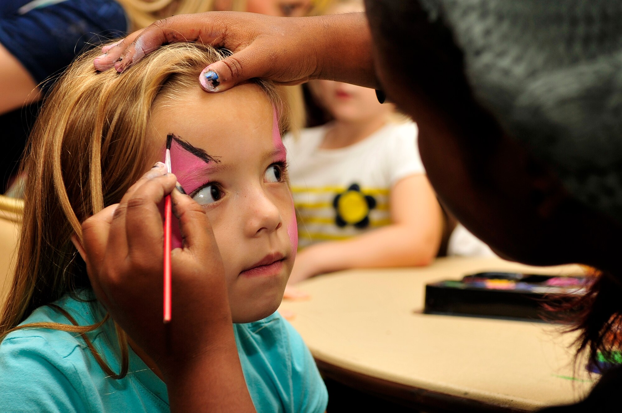 One of Team Seymour’s youngest members gets her face painted as a butterfly during a “Hearts Apart” event Oct. 24, 2014, at Seymour Johnson Air Force Base, North Carolina. The event focused on relieving the pressures families sustain when a member is deployed and served as a venue to ensure families are connected with the wing’s many helping agencies and resources. (U.S. Air Force photo/Airman 1st Class Shawna Keyes)