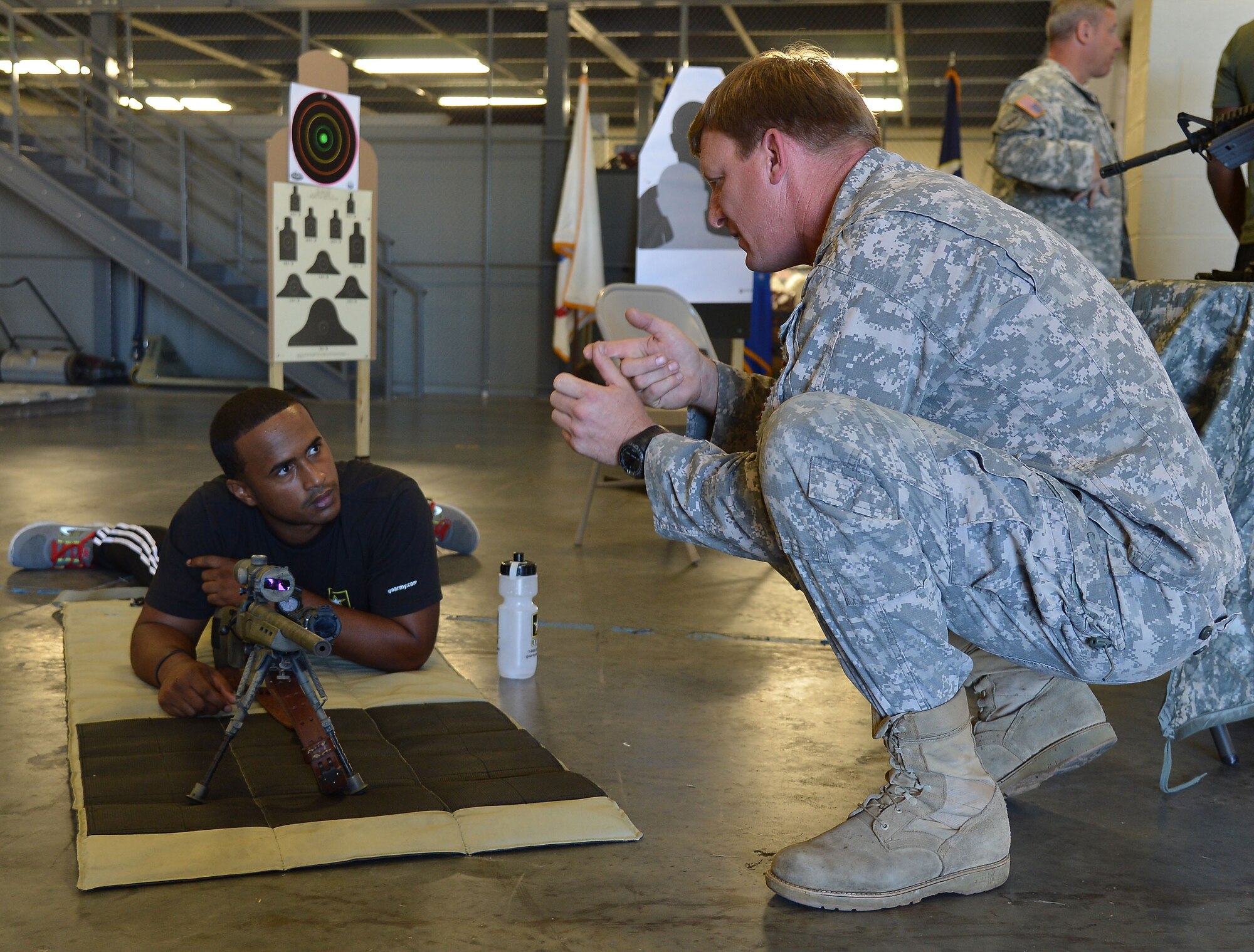 A future soldier learns how to fire a rifle during the Army Recruiting Future Soldiers Event Oct. 17, 2014 at MacDill Air Force Base, Fla. It was a three-hour event that consisted of 13 future soldiers from the Orlando Recruiting Company viewing static displays of the various missions that SOCCENT supports, including the parachute riggers. (U.S. Air Force photo by Senior Airman Jenay Randolph/Released)