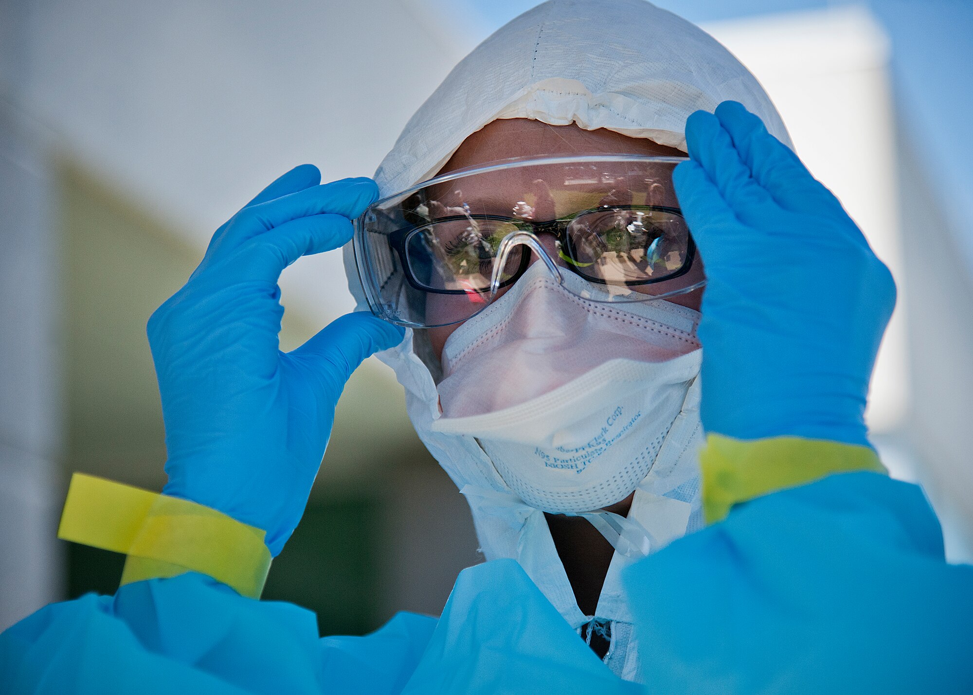 Airman 1st Class Nanci Hause, 96th Medical Group, secures her safety glasses during a disease containment exercise at Eglin Air Force Base, Fla., Oct. 22.  The base’s medical personnel performed the specific procedures required in the event of an outbreak in the local area and on base.  (U.S. Air Force photo/Samuel King Jr.)