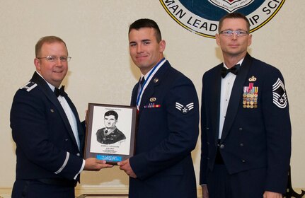 Colonel Jeffrey DeVore, Joint Base Charleston commander , and Chief Master Sgt. Robert Valenca, 628th Mission Support Group command chief, present the John L. Levitow award to Senior Airman Christopher  Whidden, 628th Civil Engineer Squadron power production journeyman Oct . 23, 2014 at the Charleston Club on JB Charleston, S.C. The John L. Levitow award is given for a student’s exemplary demonstration of excellence, both as a leader and a scholar. (U.S. Air Force photo/Airman 1st Class Clayton Cupit)