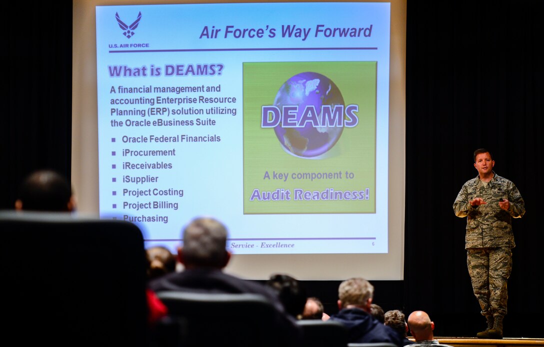 U.S. Air Force Col. Timothy Dunster, Air Combat Command financial operations chief, briefs Joint Base Langley-Eustis personnel during a town hall at Langley Air Force Base, Va., Oct. 23, 2014. The town hall was held to relay information about the Defense Enterprise Accounting and Management System that will be implemented in February 2015. (U.S. Air Force photo by Senior Airman Kayla Newman/Released)