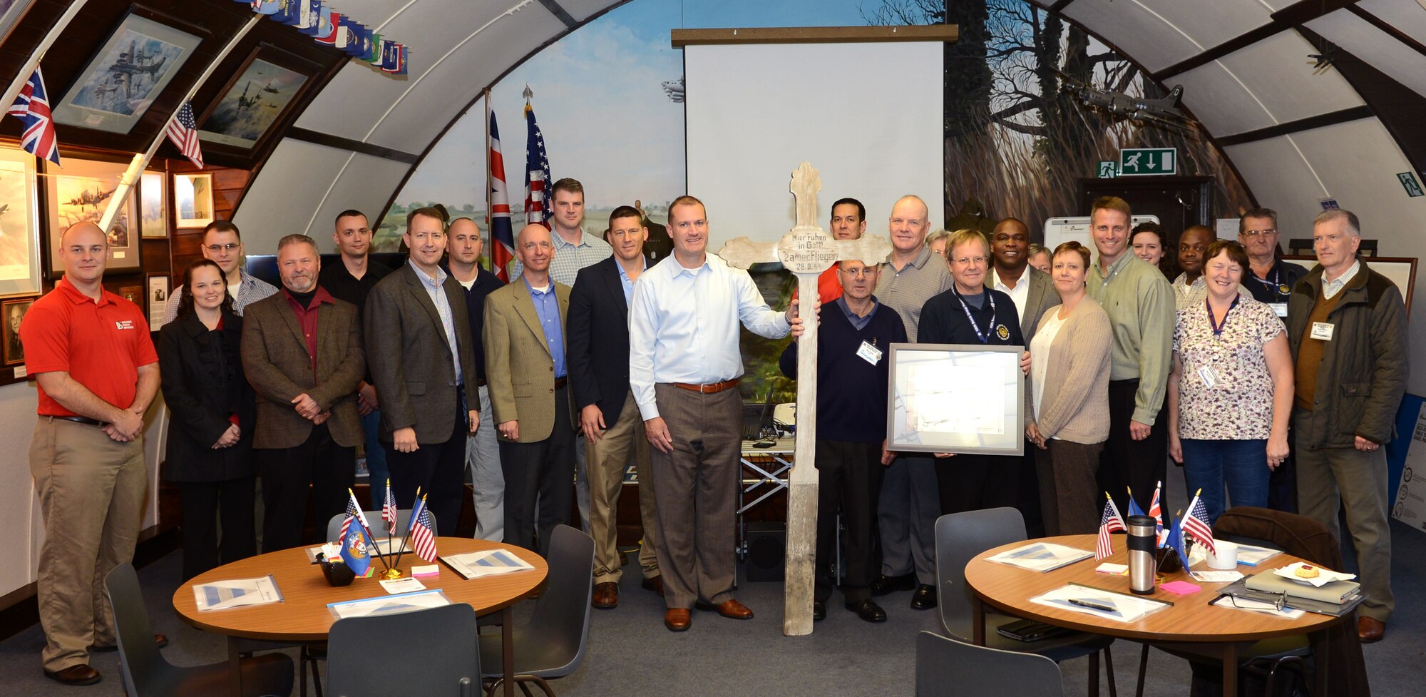 Members of Team Mildenhall and volunteers from the 100th Bomb Group Memorial Museum pose for a group photo Oct. 24, 2014, at RAF Thorpe Abbotts near Diss, England. Base leadership traveled to Thorpe Abbotts to return a grave marker originally from Germany memorializing two 100th Bombardment Group Airmen, U.S. Army Air Corps 1st Lt. Raymond Harney, B-17 Flying Fortress pilot, and his bombardier U.S. Army Air Corps 2nd Lt. Warren French, as well as to discuss wing improvement strategies. (U.S. Air Force photo by Airman 1st Class Dillon Johnston/Released)