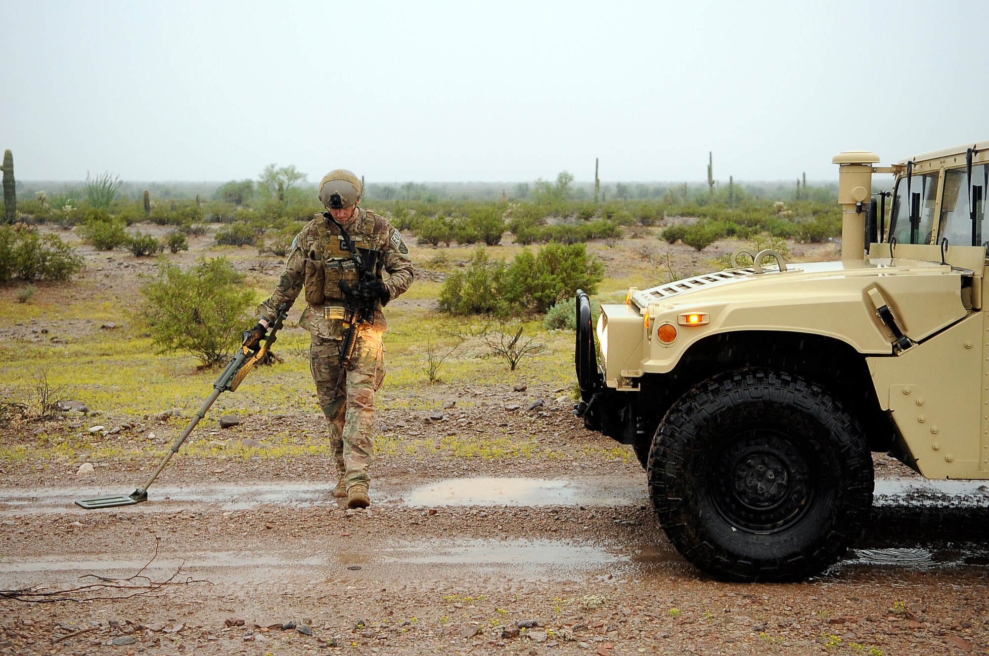 Staff Sgt. Steven Dauck, 56th CES EOD team leader, sweeps for a secondary explosive device Oct. 8 in front of a high-mobility multi-wheeled vehicle to ensure the road is clear of pressure plate improvised explosive devices. (U.S. Air Force photo/Airman 1st Class Pedro Mota)