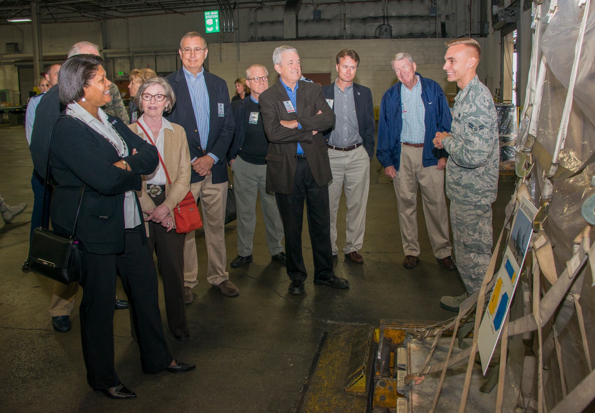 When Evelyn McDew, foreground left, wife of Air Mobility Command commander Gen. Darren McDew, asked Airman 1st Class Alexander Robinson, right, 60th Aerial Port Squadron, "You lover your job, don't you?" Robinson's response was, "Yes, ma'am. I do." The tour through the 60th APS' loading dock was a part of the AMC Civic Leaders Conference from Oct. 14 to 17 at Travis Air Force Base. (U.S. Air Force photo by Heide Couch)