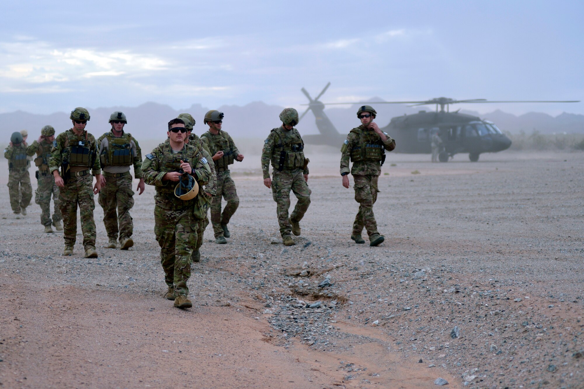 Airmen from Luke Air Force Base and Davis-Monthan AFB, Tucson, head toward the Gila Bend training range after being dropped off by a UH-60 helicopter. This joint base operation was conducted Oct. 7 through 10 to train explosive ordnance disposal Airmen for war-zone scenarios. (U.S. Air Force photo/Airman 1st Class Pedro Mota)