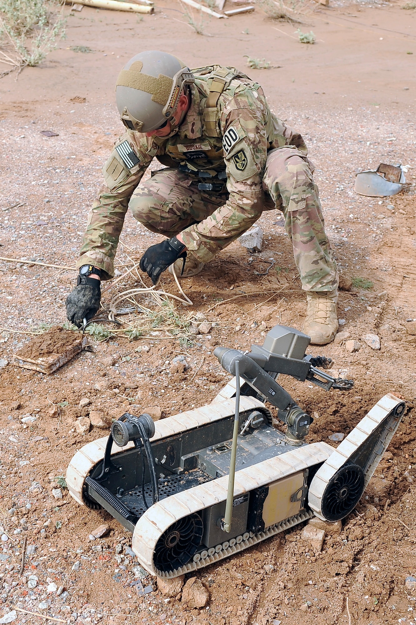 Staff Sgt. Steven Dauck, 56th CES EOD team leader, unhooks a rope from a pressure plate IED Oct. 8 after a remote-remove procedure was completed. Dauck collected the pressure plate portion of the IED for evidence to attack the IED network. (U.S. Air Force photo/Airman 1st Class Pedro Mota)