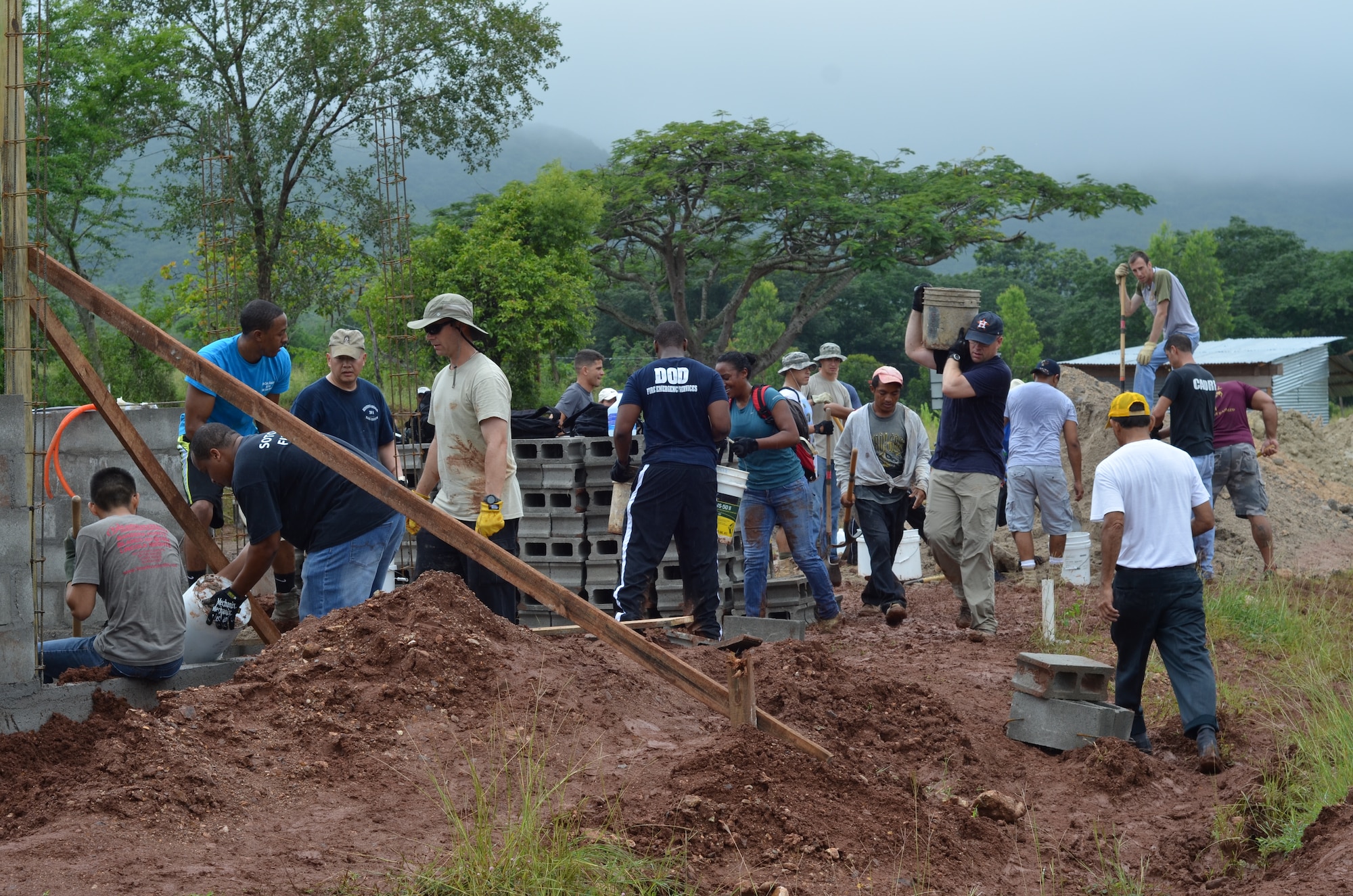 Twenty-seven volunteers from Joint Task Force- Bravo help carry cement blocks and shovel dirt for the foundation of 10 homes during a Habitat for Humanity build in La Paz, Honduras, Oct. 18, 2014.   The homes are the first of 20 homes that will eventually be built in the new La Paz site, and they are expected to be completed by Dec. 20, 2014.  Founded in 1976, Habitat for Humanity is a nonprofit, ecumenical Christian ministry dedicated to building and repairing homes with those in need.  Habitat for Humanity’s work began in Honduras in 1988 and over the years, reached more than 70 communities and served over 15,240 families. (U.S. Air Force Photo/Capt. Connie Dillon)