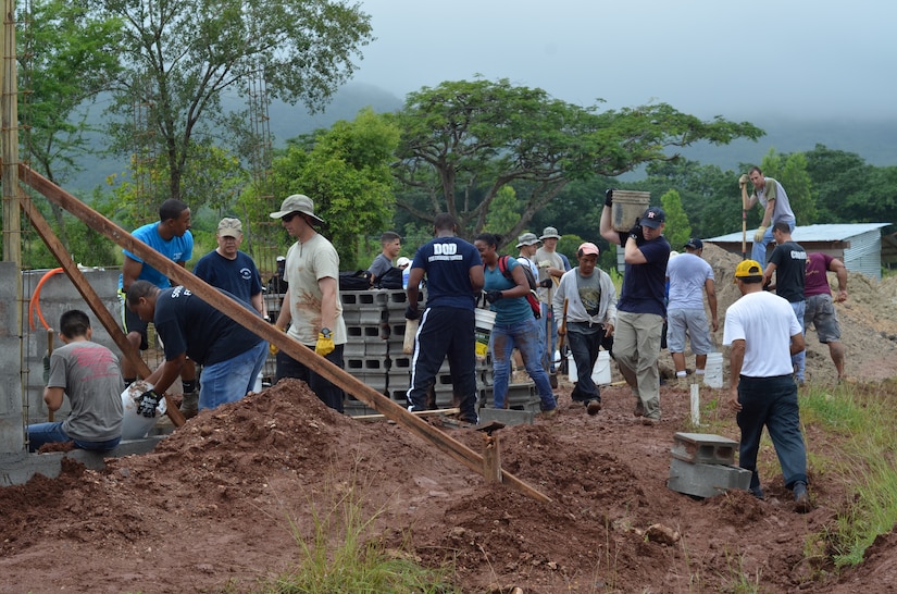 Twenty-seven volunteers from Joint Task Force- Bravo help carry cement blocks and shovel dirt for the foundation of 10 homes during a Habitat for Humanity build in La Paz, Honduras, Oct. 18, 2014.   The homes are the first of 20 homes that will eventually be built in the new La Paz site, and they are expected to be completed by Dec. 20, 2014.  Founded in 1976, Habitat for Humanity is a nonprofit, ecumenical Christian ministry dedicated to building and repairing homes with those in need.  Habitat for Humanity’s work began in Honduras in 1988 and over the years, reached more than 70 communities and served over 15,240 families. (U.S. Air Force Photo/Capt. Connie Dillon)