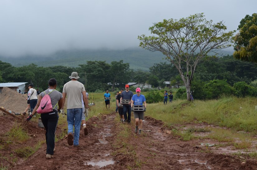 Twenty-seven volunteers from Joint Task Force- Bravo help carry cement blocks and shovel dirt for the foundation of 10 homes during a Habitat for Humanity build in La Paz, Honduras, Oct. 18, 2014.   The homes are the first of 20 homes that will eventually be built in the new La Paz site, and they are expected to be completed by Dec. 20, 2014.  Founded in 1976, Habitat for Humanity is a nonprofit, ecumenical Christian ministry dedicated to building and repairing homes with those in need.  Habitat for Humanity’s work began in Honduras in 1988 and over the years, reached more than 70 communities and served over 15,240 families. (U.S. Air Force Photo/Capt. Connie Dillon)