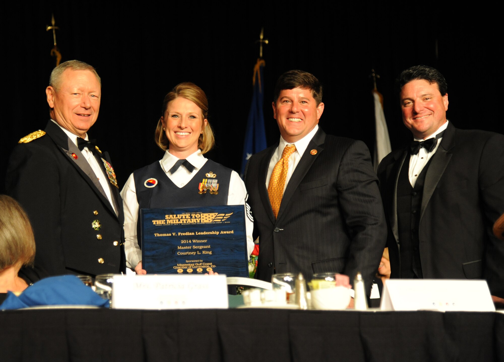 Gen. Frank Grass, Chief of the National Guard Bureau, Joint Chiefs of Staff, Washington, D.C.; Master Sgt. Courtney King, Mathies NCO Academy instructor, Keesler Air Force Base; Congressman Steven Palazzo, Mississippi’s Fourth Congressional District, and  Mississippi Gulf Coast Chamber of Commerce President Eric Kravette, pose for a photo during the 36th Annual Salute to the Military Oct. 21, 2014, at the Mississippi Coast Coliseum in Biloxi, Miss. King was recognized as the winner of the Thomas V. Fredian Community Leadership Award at the event. (U.S. Air Force photo by Kemberly Groue)