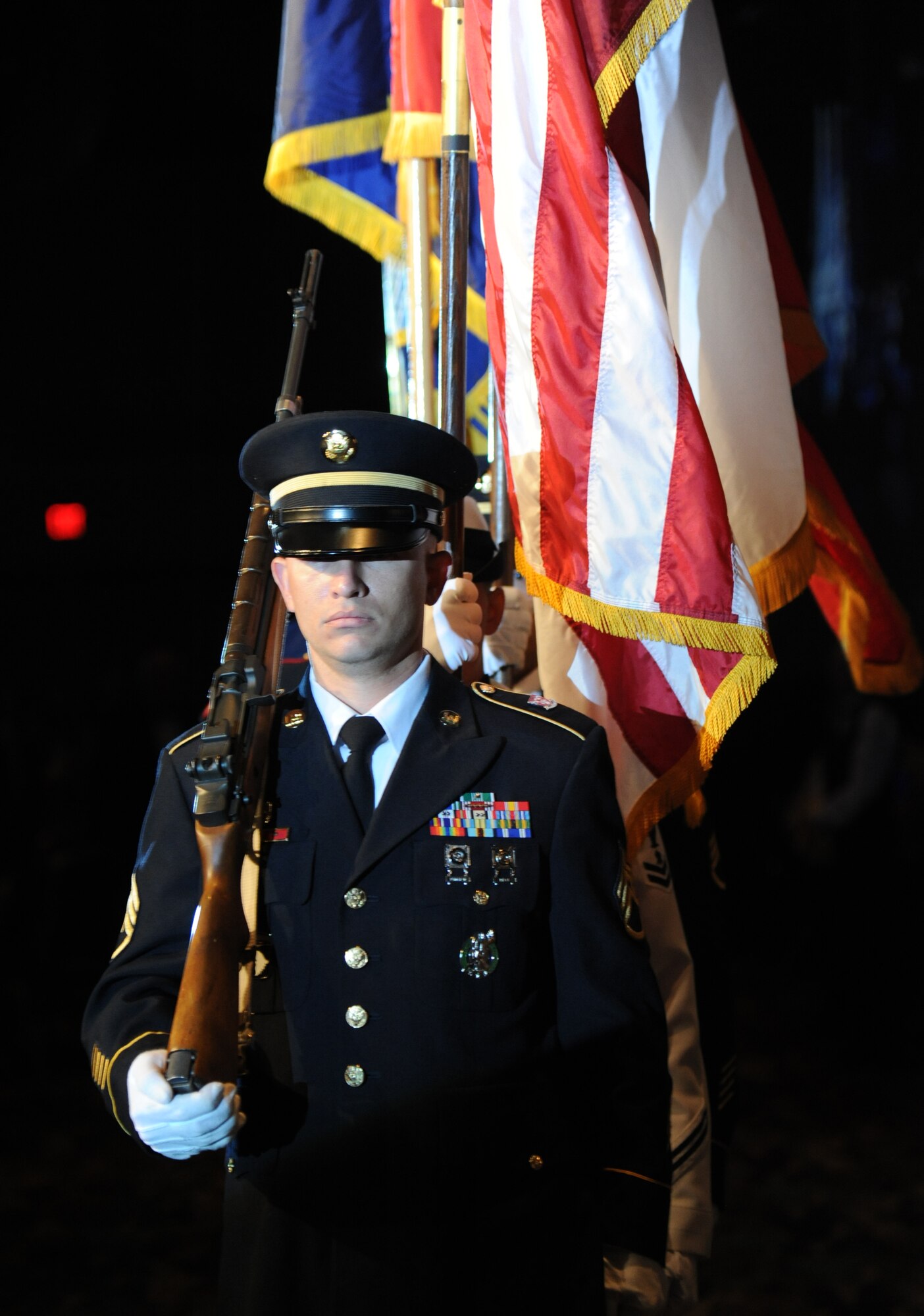 The color guard representing each branch of the military posts the Colors during the 36th Annual Salute to the Military Oct. 21, 2014, at the Mississippi Coast Coliseum in Biloxi, Miss.   Master Sgt. Courtney King, Mathies NCO Academy instructor, Keesler Air Force Base, was recognized as the winner of the Thomas V. Fredian Community Leadership Award at the event. (U.S. Air Force photo by Kemberly Groue)