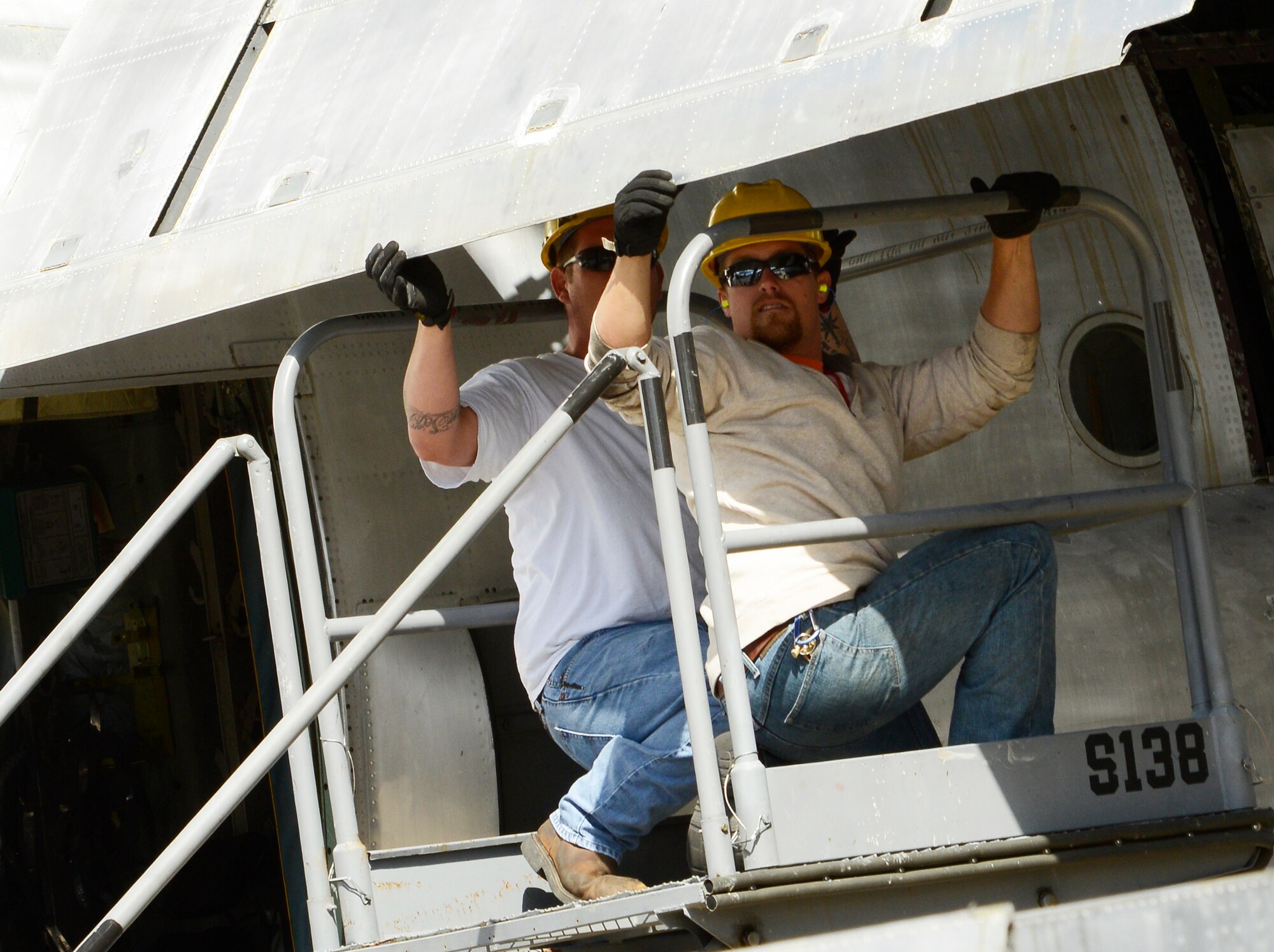 Austin Brown and Shane Williams, C-130 strip crew, prep a flap for
disassembly and removal. (U.S. Air Force photo by Ed Aspera)