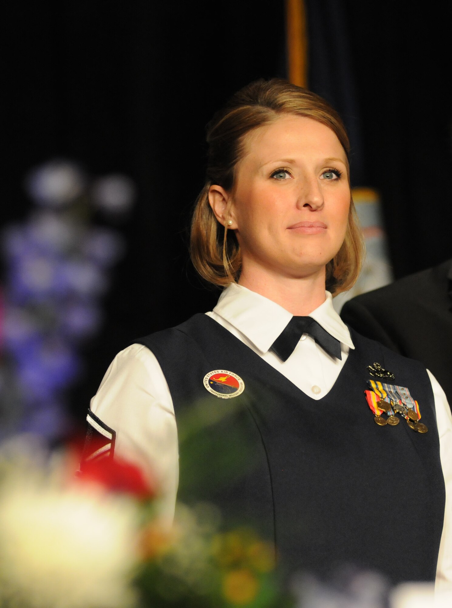 Master Sgt. Courtney King, Mathies NCO Academy instructor, Keesler Air Force Base, receives a plaque from members of the head table during the 36th Annual Salute to the Military Oct. 21, 2014, at the Mississippi Coast Coliseum in Biloxi, Miss.  King was recognized as the winner of the Thomas V. Fredian Community Leadership Award at the event. (U.S. Air Force photo by Kemberly Groue)