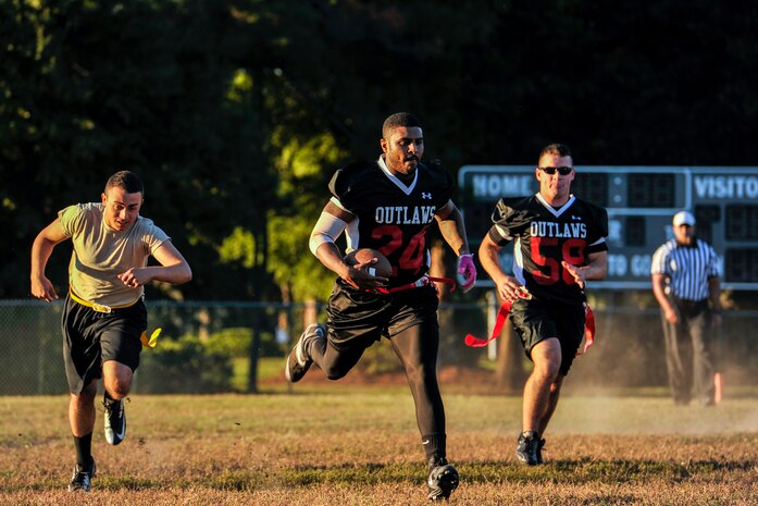 Senior Airman Ryan Galbreith, 628th Civil Engineer Squadron structural technician, streaks toward the end zone during the opening game of the Air Base intramural flag football season Oct. 21, 2014, at Joint Base Charleston, S.C. The 628th CES beat the 437th Aircraft Maintenance Squadron 24-14. (U.S. Air Force photo/Staff Sgt. Renae Pittman)