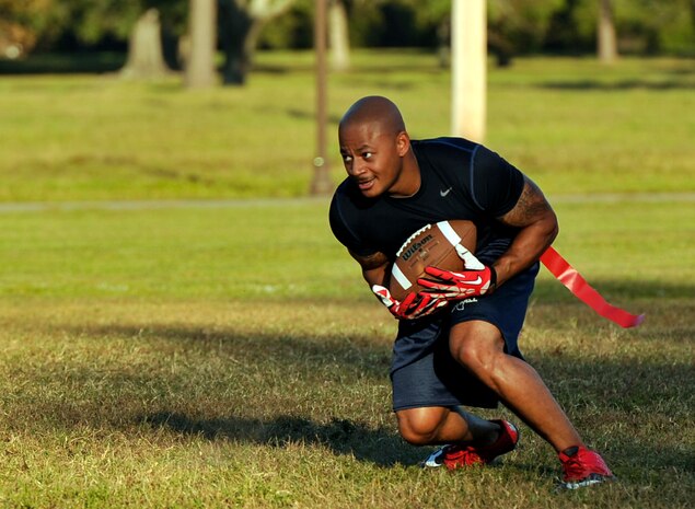 Staff Sgt. Leatrice Robinson, 628th Civil Engineer Squadron crew chief, returns a punt during an intramural flag football game Oct. 21, 2014, at Joint Base Charleston, S.C. Each Air Base intramural team will play 13 games prior to the championship scheduled for early December. (U.S. Air Force photo/Staff Sgt. Renae Pittman)