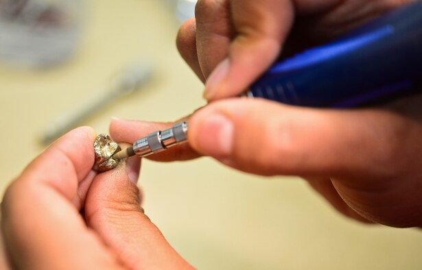 Staff Sgt. Gina Rosales, 28th Medical Operation Squadron dental laboratory technician, fabricates a metal crown for a patient at Ellsworth Air Force Base, S.D., Oct. 17, 2014. Rosales is entrusted with the fabrication and repair of dentures, metal or porcelain crowns, bridges, orthodontic devices, mouth guards and other types of appliances designed to restore the appearance, function and health in patients. (U.S. Air Force photo by Senior Airman Zachary Hada/Released)
