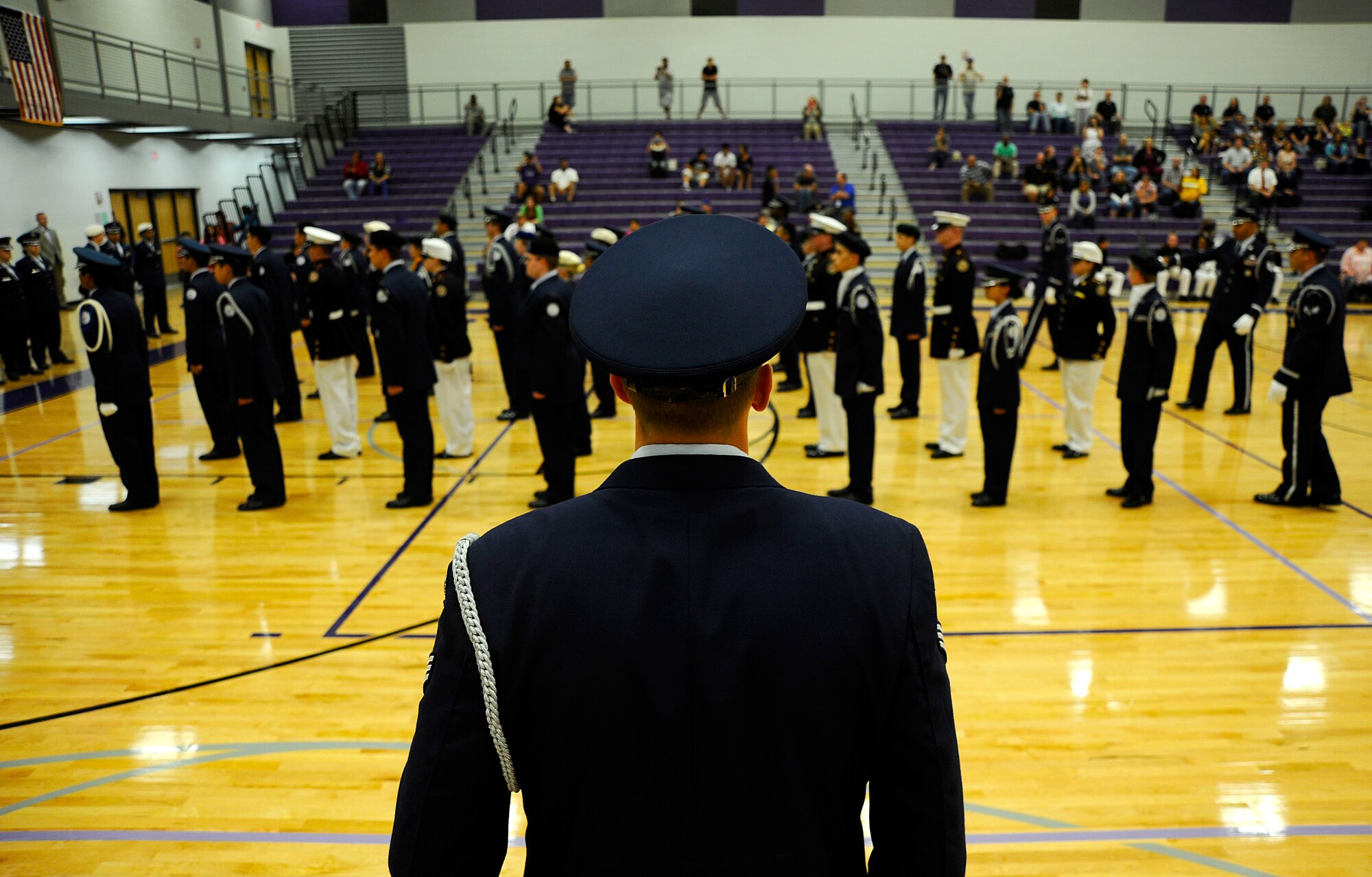 (Center) Senior Airman David Clauson, 22nd Force Support Squadron Honor Guardsman, calls drill movements during the individual drill down portion of a Junior ROTC competition, Oct. 20, at Wichita Northeast Magnet High School, Bel Aire, Kan. Clauson and several other Airmen from the McConnell Air Force Base Honor Guard were the guest judges for the Wichita Public Schools district JROTC competitions this semester. (U.S. Air Force photo/Senior Airman Victor J. Caputo)
