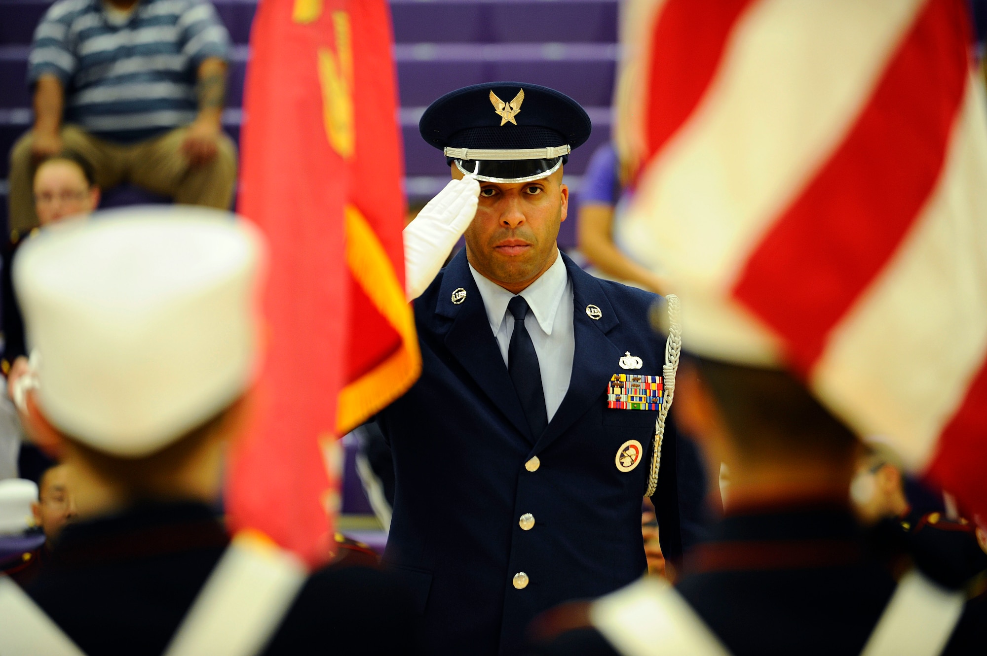 Tech. Sgt. Terrance Williams, 22nd Force Support Squadron Honor Guard NCO in charge, returns a salute to a team of Junior ROTC cadets during a competition, Oct. 20, at Wichita Northeast Magnet High School, Bel Aire, Kan. Williams was the head judge on a team of Airmen from the McConnell Air Force Base Honor Guard during a regional JROTC drill compeition for the Wichita Public Schools district. (U.S. Air Force photo/Senior Airman Victor J. Caputo)