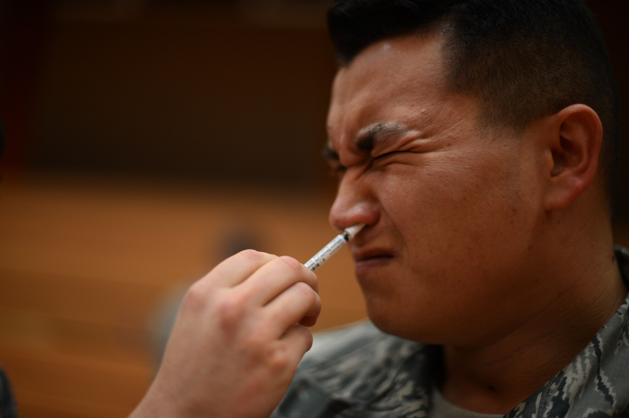 U.S. Air Force Staff Sgt. Dan Jackson, 52nd Civil Engineer Squadron Emergency Management flight technician from South Hadley, Mass., receives a flu mist vaccine inside the Skelton Memorial Fitness Center at Spangdahlem Air Base, Germany, Oct. 23, 2014. The 52nd MDG hosts the mass vaccinations once per year. (U.S. Air Force photo by Senior Airman Gustavo Castillo/Released)  