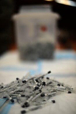 A pile of influenza vaccine applicators rest on a table inside the Skelton Memorial Fitness Center at Spangdahlem Air Base, Germany, Oct. 23, 2014. The vaccine must be stored between 2 and 8 degrees Celsius and only allowed to be out of that temperature once in its lifetime before use. (U.S. Air Force photo by Senior Airman Gustavo Castillo/Released) 