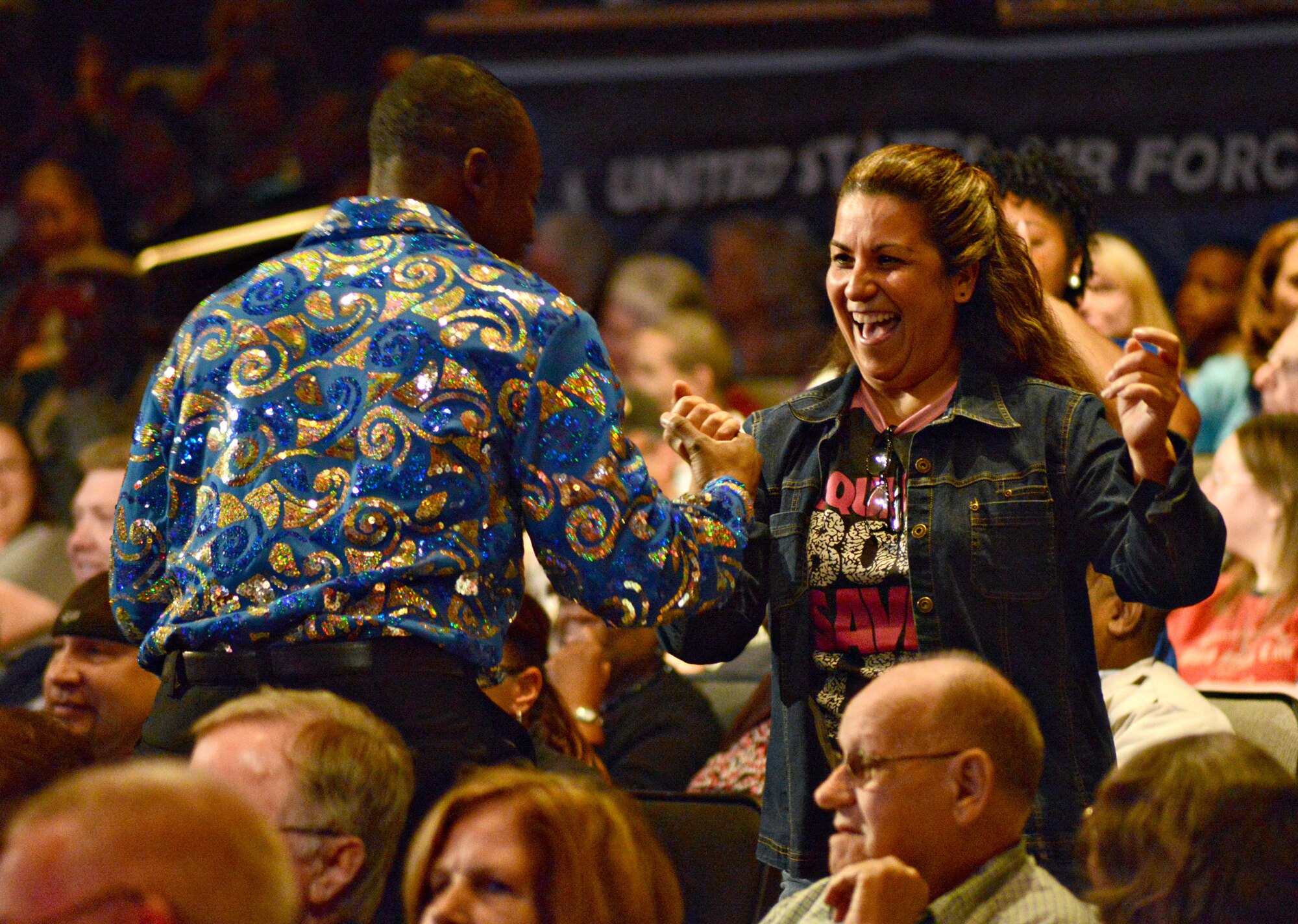 The Tops in Blue vocalists got the audience members out of their seats and on their feet by dancing in the aisles during their concert Oct. 18 at Rose State College. (Air Force photo by Kelly White)