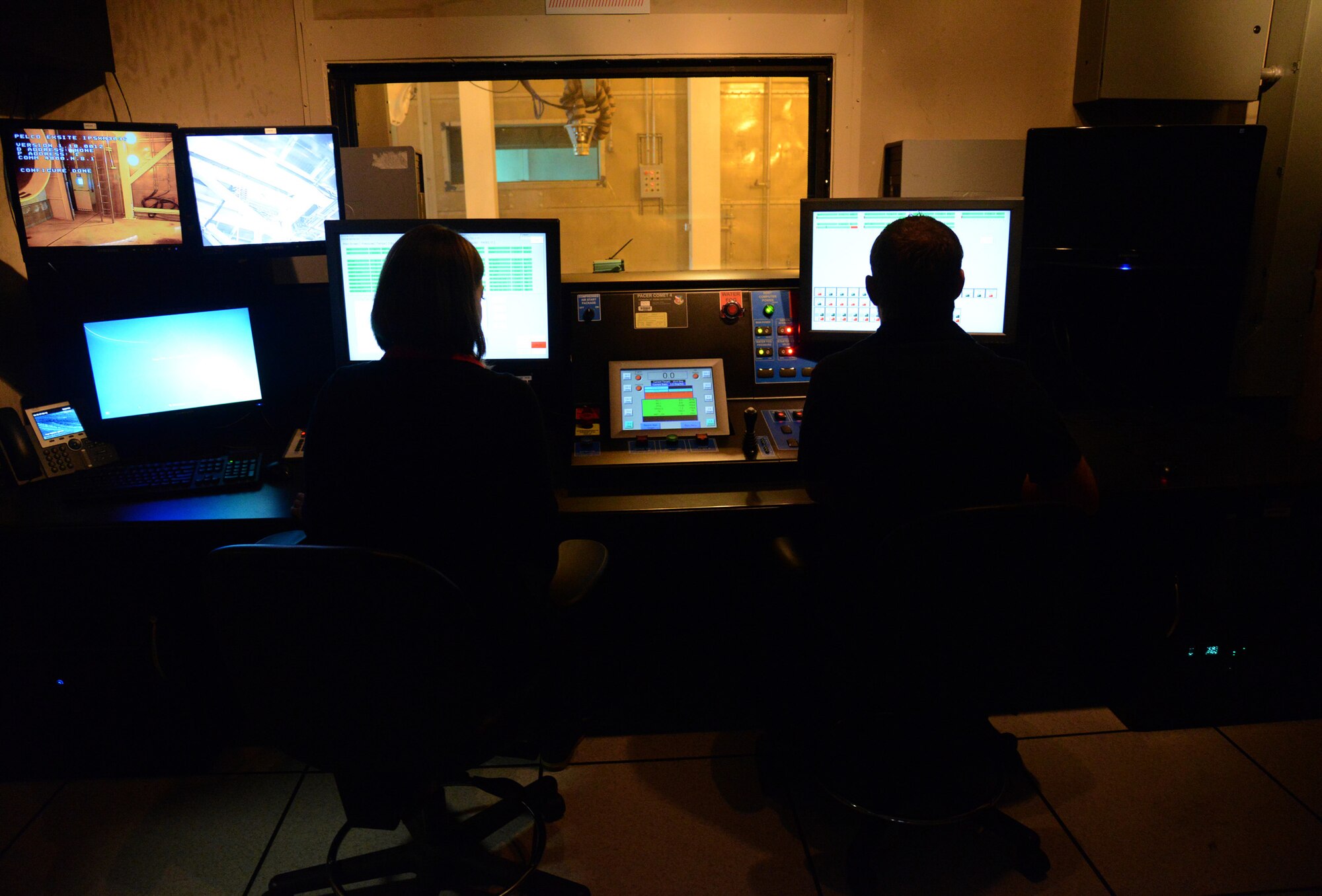 Shondra Fischer and Blake Cunningham, electronics engineers with the 555th Software Maintenance Squadron, make sure everything is running smoothly with the recently-implemented Pacer Comet 4 system in the T-9 Test Cells. The engineers helped to design the system, tore down and installed the new equipment and will make new designs to the system as needed. (Air Force photo by Kelly White)