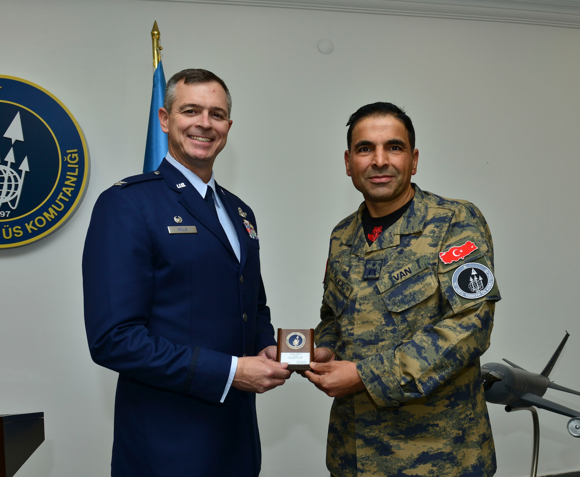 Col. Craig Wills, 39th Air Base Wing commander recieves a coin from Brig. Gen. Bekir Ercan VAN, incoming 10th Tanker Base commander Oct. 22, 2014, Incirlik Air Base, Turkey.  VAN is serving his second tour at the 10th TBC after being assigned here in 2011-2012. (U.S. Air Force photo by Senior Airman Nicole Sikorski/Released)
