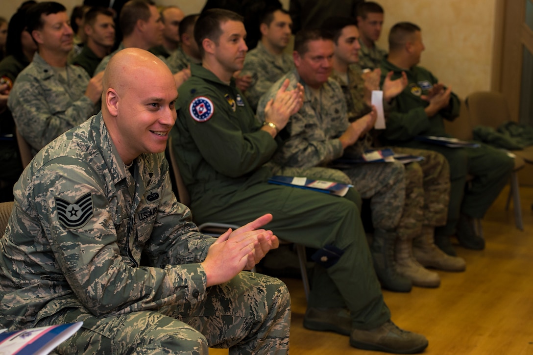 U.S. Air Force Airmen assigned to the 182nd Airlift Wing, Illinois Air National Guard, Peoria, Ill., and Detachment 1, 52nd Operations Group, from Lask Air Base, Poland, applaud students during their visit at Zespol Szkol Ponadgimnazjalnych W Kleczewie, a Polish high school, in Kleczewie, Poland, Oct. 21, 2014. More than 20 Airmen volunteered to visit the school during their free time in order to reach out to the community surrounding Powidz Air Base, Poland. (U.S. Air Force photo by Staff Sgt. Christopher Ruano/Released)