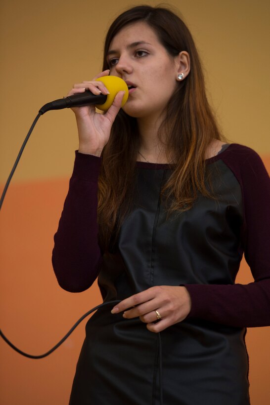 Daria Hartwich, a student, sings for U.S. Air Force Airmen assigned to the 182nd Airlift Wing, Illinois Air National Guard, Peoria, Ill., and Detachment 1, 52nd Operations Group, from Lask Air Base, Poland, at Zespol Szkol Ponadgimnazjalnych W Kleczewie, a Polish high school, in Kleczewie, Poland, Oct. 21, 2014. The school welcomed the Airmen, presented songs, held a question-and-answer session and invited them to play volleyball. (U.S. Air Force photo by Staff Sgt. Christopher Ruano/Released)