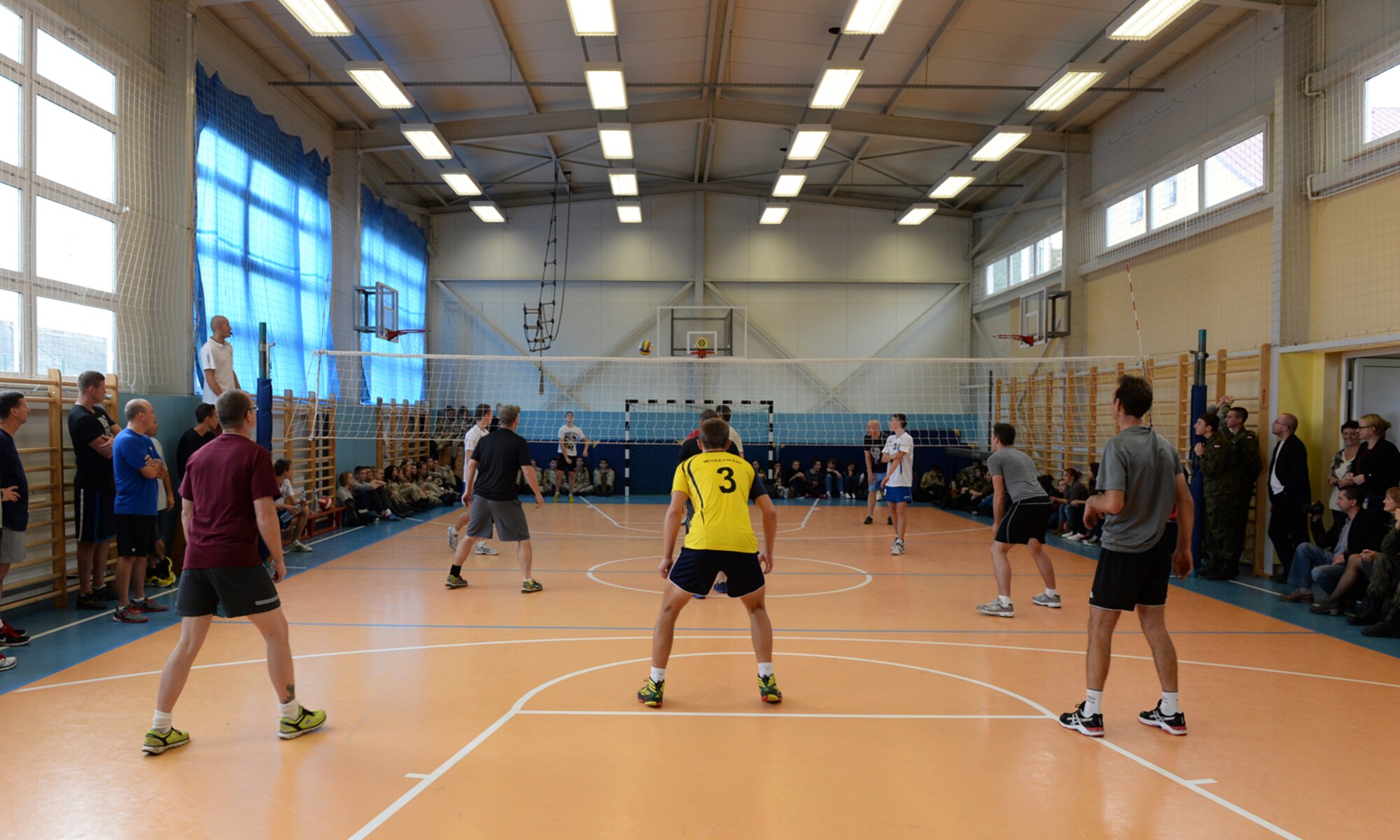 U.S. Air Force Airmen assigned to the 182nd Airlift Wing, Illinois Air National Guard, Peoria, Ill., and Detachment 1, 52nd Operations Group, from Lask Air Base, Poland,, play volleyball against students from Zespol Szkol Ponadgimnazjalnych W Kleczewie, a Polish high school, during a school visit Oct. 21, 2014, at the school in Kleczewie, Poland. Airmen played a game against the school team before mixing teams and playing another game during the visit. The 182nd AW is supporting rotation 15-1 hosted by the Aviation Detachment. The rotation serves as part of a bilateral training with Poland to maintain joint readiness, build interoperability and reassure allies and partners. (U.S. Air Force photo by Airman 1st Class Dylan Nuckolls/Released)