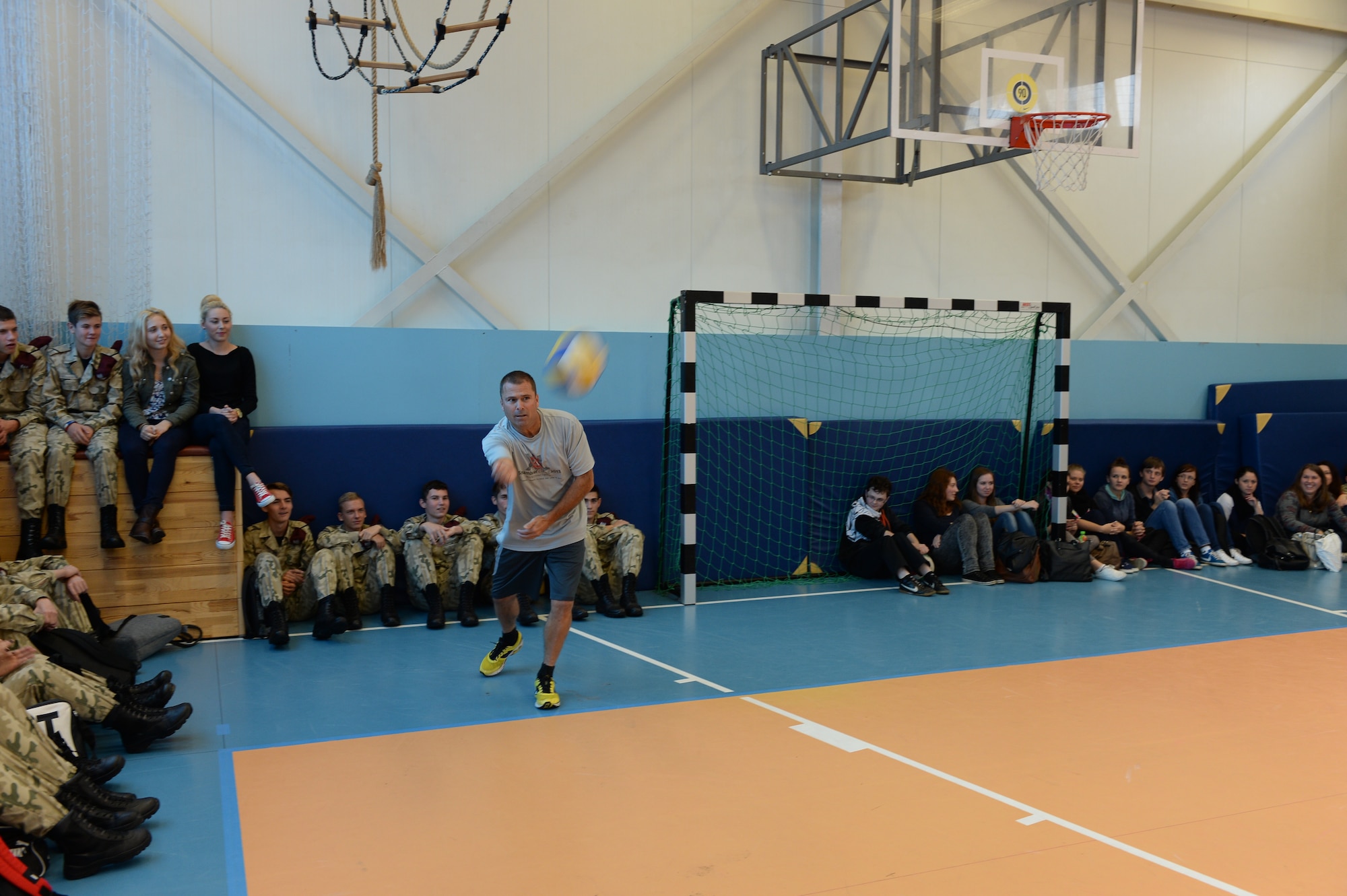 U.S. Air Force Airmen assigned to the 182nd Airlift Wing, Illinois Air National Guard, Peoria, Ill., and Detachment 1, 52nd Operations Group, from Lask Air Base, Poland,, play volleyball against students from Zespol Szkol Ponadgimnazjalnych W Kleczewie, a Polish high school, during a school visit Oct. 21, 2014, at the school in Kleczewie, Poland. Airmen played a game against the school team before mixing teams and playing another game during the visit. The 182nd AW is supporting rotation 15-1 hosted by the Aviation Detachment. The rotation serves as part of a bilateral training with Poland to maintain joint readiness, build interoperability and reassure allies and partners. (U.S. Air Force photo by Airman 1st Class Dylan Nuckolls/Released)