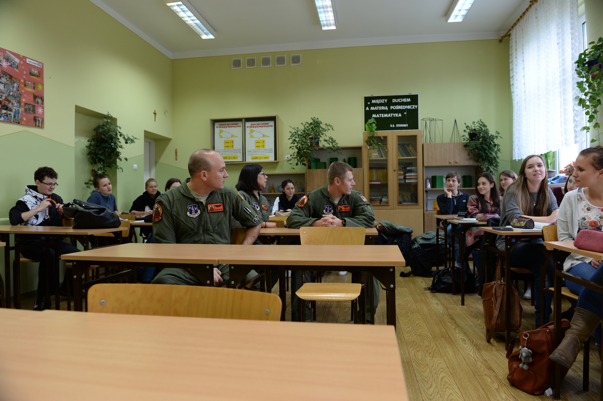 U.S. Air Force Airmen assigned to the 182nd Airlift Wing, Illinois Air National Guard, Peoria, Ill., talk with students from Zespol Szkol Ponadgimnazjalnych W Kleczewie, a Polish high school, during a school visit Oct. 21, 2014, at the school in Kleczewie, Poland. Roughly 20 Airmen split into groups and answered questions asked by the students during the visit. The 182nd AW is supporting rotation 15-1 hosted by Detachment 1, 52nd Operations Group, from Lask Air Base, Poland. (U.S. Air Force photo by Airman 1st Class Dylan Nuckolls/Released)