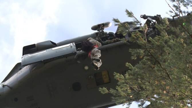An HH-60G Pave Hawk pilot pulls U.S. Air Force Tech. Sgt. Jeffrey Farris, 5th Reconnaissance Squadron quality assurance chief inspector, into the helicopter during a combat search and rescue training scenario at an off base training site, Republic of Korea, Oct. 14, 2014. CSAR is a specific task performed by rescue forces to help recover distressed personnel during war or military operations other than war. (U.S. Air Force photo by Senior Airman Lindy Pata/Released) 