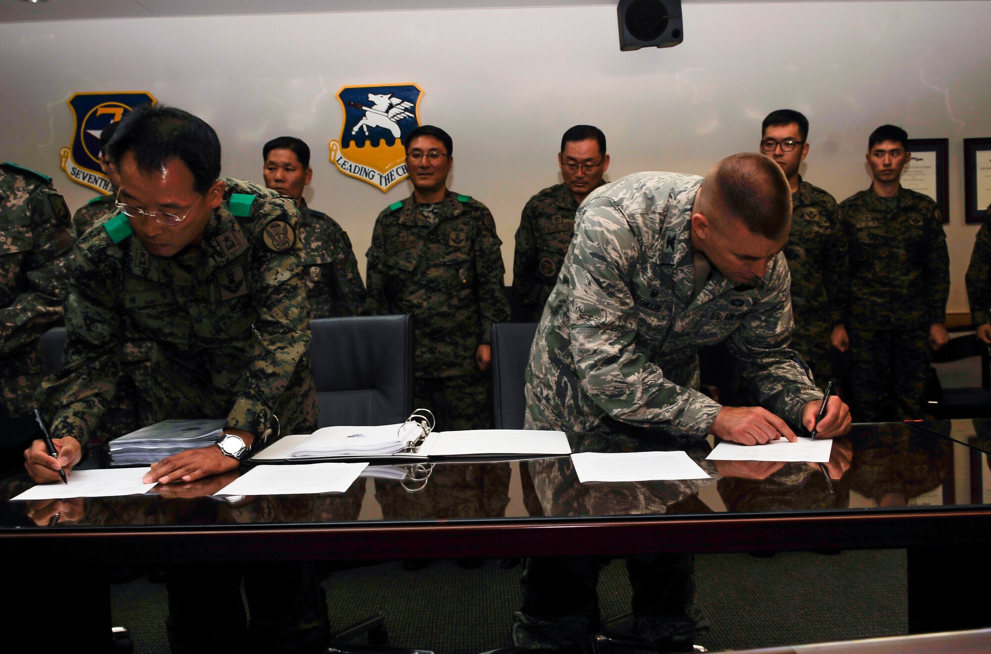 Republic of Korea army Brig. Gen. Sam Kwon, 9th Special Forces Brigade commander, left, and Col. Brook Leonard, 51st Fighter Wing commander, sign the Combined Defense Plan Oct. 21, 2014, Osan Air Base, ROK. The CDP is the joint plan that ties U.S. and ROK forces together to defend Osan AB, and strengthens the relations between the two nations as we move forward as a unified team. The CDP identifies each element’s roles and capabilities, and provides clear guidance on interoperability during training and real-world scenarios. 